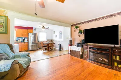 a living room with a large flat screen tv at Cozy Ballston Spa Home with Fenced Yard! in Malta