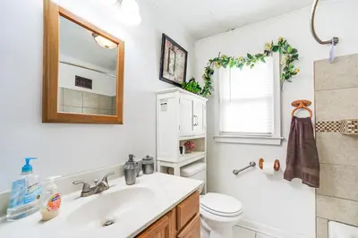 a bathroom with a sink and a toilet and a mirror at Cozy Ballston Spa Home with Fenced Yard! in Malta