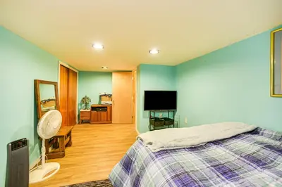 a bedroom with a bed and a flat screen tv at Cozy Ballston Spa Home with Fenced Yard! in Malta