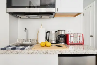 a kitchen counter with some fruit on a cutting board at 73-1503 Newly Reno Studio UWS Doorman Gym Laundry in New York