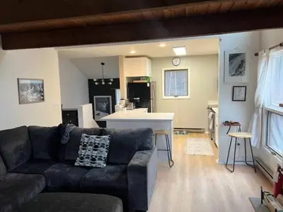 a living room with a couch and a kitchen at Hunter Mountain Slope Side Home in Lanesville