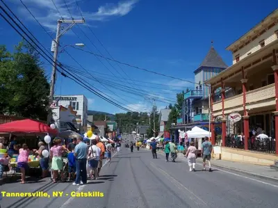 a crowd of people walking down a street in a town at Hunter Mountain Slope Side Home in Lanesville