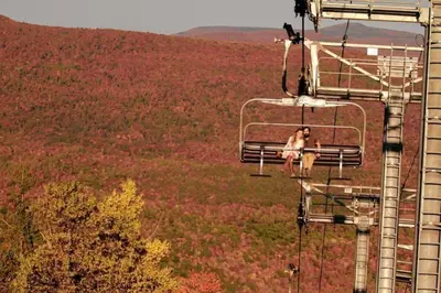 a couple of people riding a ski lift at Hunter Mountain Slope Side Home in Lanesville