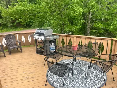 a grill on a deck with a table and chairs at Hunter Mountain Slope Side Home in Lanesville