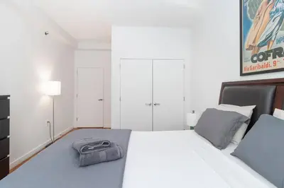 a bedroom with a bed with a purse on it at Central Park North - Quiet Place in New York