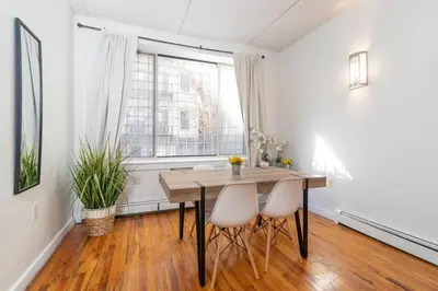 a dining room with a table and two chairs at Central Park North - Quiet Place in New York