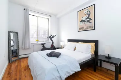 a bedroom with a bed and a desk in it at Central Park North - Quiet Place in New York