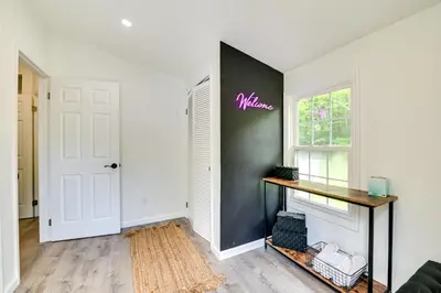 a living room with a black accent wall and a window at Catskills Family Retreat Fishing and Hiking On-Site in East Durham