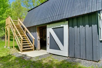 a barn with a large door and a set of stairs at Catskills Family Retreat Fishing and Hiking On-Site in East Durham