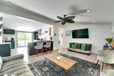 a living room with a couch and a ceiling fan at Catskills Family Retreat Fishing and Hiking On-Site in East Durham
