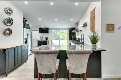 a kitchen with a large kitchen island with bar stools at Catskills Family Retreat Fishing and Hiking On-Site in East Durham