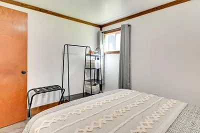 a bedroom with a bed and a window at Cozy Catskills Cabin - 12 Mi to Windham Mountain! in East Durham