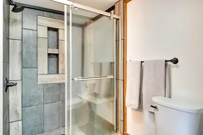 a bathroom with a shower and a toilet at Cozy Catskills Cabin - 12 Mi to Windham Mountain! in East Durham