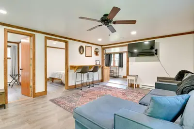 a living room with a couch and a ceiling fan at Cozy Catskills Cabin - 12 Mi to Windham Mountain! in East Durham