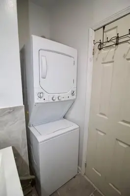 a white refrigerator with a tv on top of it at Tuk Ahoy - Sapphire Suite 1B with Shared Spaces in Brooklyn