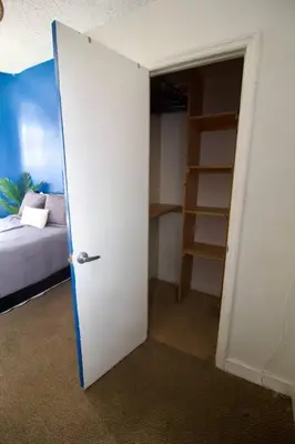 a room with a door leading to a bedroom with a bed at Tuk Ahoy - Sapphire Suite 1B with Shared Spaces in Brooklyn
