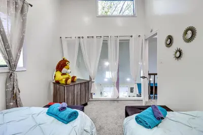 a bedroom with two beds and a stuffed animal at Hot Tub and Lake Beach Access Tobyhanna Retreat! in Tobyhanna