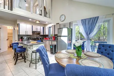 a kitchen and dining room with a table and chairs at Hot Tub and Lake Beach Access Tobyhanna Retreat! in Tobyhanna
