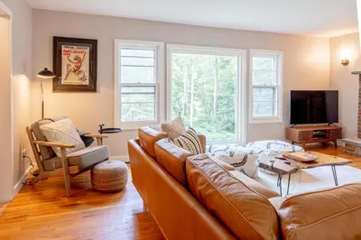 a living room with a couch and a tv at Modern Rustic Escape w/Hot Tub - High Falls Lodge in Saugerties