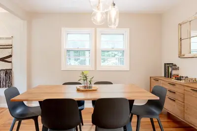 a dining room with a wooden table and chairs at Modern Rustic Escape w/Hot Tub - High Falls Lodge in Saugerties