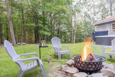 three chairs around a fire pit in a yard at Modern Rustic Escape w/Hot Tub - High Falls Lodge in Saugerties