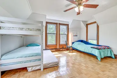 two bunk beds in a bedroom with a ceiling fan at Family Home with Yard and Fire Pit in Middleburgh! in Middleburgh