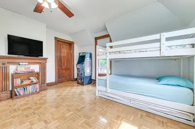 a bedroom with a bunk bed and a flat screen tv at Family Home with Yard and Fire Pit in Middleburgh! in Middleburgh