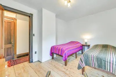 a room with two beds and a table and a window at Family Home with Yard and Fire Pit in Middleburgh! in Middleburgh