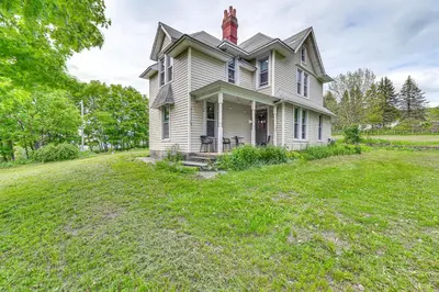 an old house with a red chimney on top of it at Family Home with Yard and Fire Pit in Middleburgh! in Middleburgh