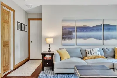 a living room with a couch and a table at Saratoga Guest House in Saratoga Springs