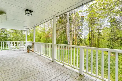 a porch of a home with a view of the woods at 8 Mi to Mount Snow Rustic Marlboro Cottage in Brattleboro