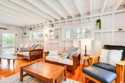 a living room with couches and a coffee table at 8 Mi to Mount Snow Rustic Marlboro Cottage in Brattleboro