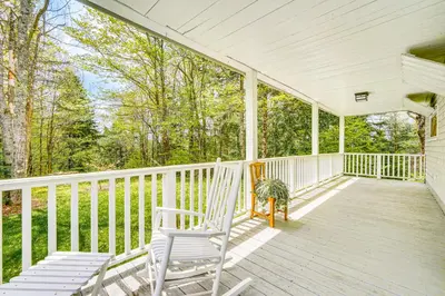 a white porch with two chairs on it at 8 Mi to Mount Snow Rustic Marlboro Cottage in Brattleboro