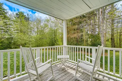 two chairs and a table on a porch at 8 Mi to Mount Snow Rustic Marlboro Cottage in Brattleboro