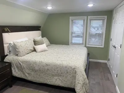 a bedroom with a bed and two windows at Huge Family House 12 miles to NYC4BathParking in Belleville