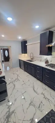 a kitchen with a marble floor with a sink and counters at Huge Family House 12 miles to NYC4BathParking in Belleville