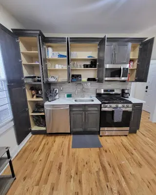 a kitchen with stainless steel appliances and wooden floors at OoohLaLa! 2 Beds and 2 Full Baths w/Free Parking in Newark