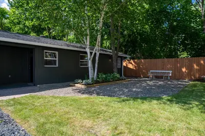 a backyard with a bench and a fence at Bronze Suite in Greenwood Lake