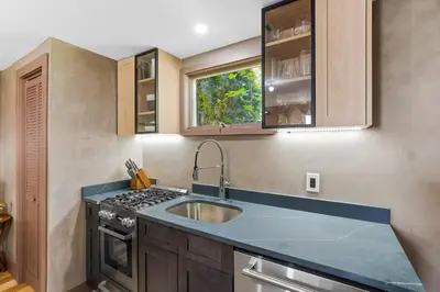 a kitchen with a sink and a stove at Bronze Suite in Greenwood Lake
