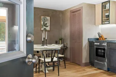 a small kitchen with a table and chairs in it at Bronze Suite in Greenwood Lake