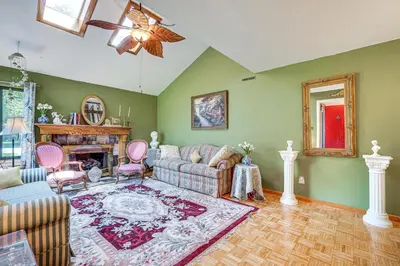 a living room with a couch and a fireplace at French-Inspired Townhome 9 Mi to Saratoga Springs! in Malta