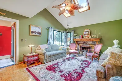 a living room with a couch and chairs and a fireplace at French-Inspired Townhome 9 Mi to Saratoga Springs! in Malta