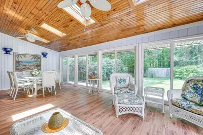 a living room with rocking chairs and a table at French-Inspired Townhome 9 Mi to Saratoga Springs! in Malta