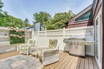 a kitchen with two chairs and a sink on a deck at French-Inspired Townhome 9 Mi to Saratoga Springs! in Malta