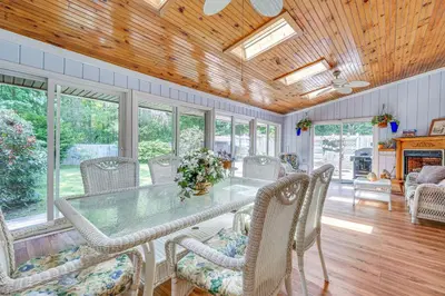 a dining room with a glass table and chairs at French-Inspired Townhome 9 Mi to Saratoga Springs! in Malta