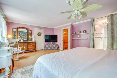 a bedroom with a white bed and a ceiling fan at French-Inspired Townhome 9 Mi to Saratoga Springs! in Malta