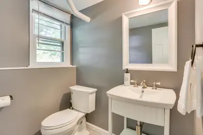 a bathroom with a white toilet and a sink at Charming Highland Falls Home Less Than 2 Mi to West Point! in Highland Falls