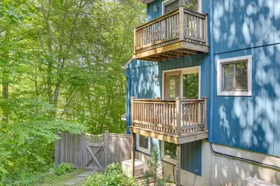 a blue house with balconies on the side of it at Cozy Woodland Home! Ski and Hike Coastal Connecticut in Killingworth