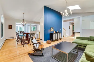 a living room with a couch and a table at Cozy Woodland Home! Ski and Hike Coastal Connecticut in Killingworth