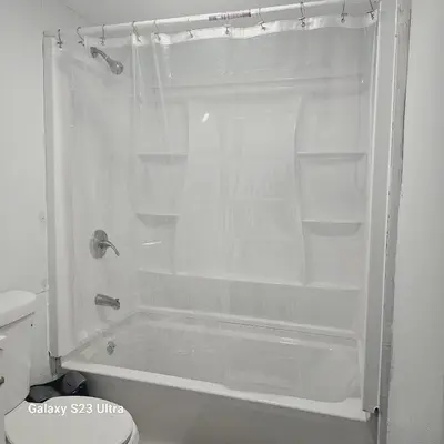 a white shower with empty shelves in a bathroom at Divine Villa Guest House Harper Ave WITH FREE PRIVATE PARKING in Irvington